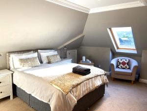 a bedroom with a large bed and a chair at 26 Green Drive Inverness in Inshes