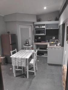 a kitchen with a table and chairs in a kitchen at La Chapelle - The Apartment in Montagu