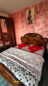 a bedroom with a bed with a wooden head board at Central City Park in Bacău