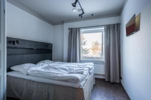 a bedroom with a bed and a window at Hotell Grelsby Strand in Godby