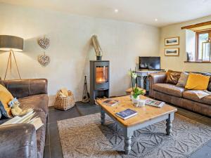 a living room with couches and a wood stove at 3 Bed in Govilon 59730 in Govilon