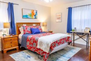 a bedroom with a bed with blue curtains and a table at Modern Chic 2-Bedroom Apartment in Atlanta