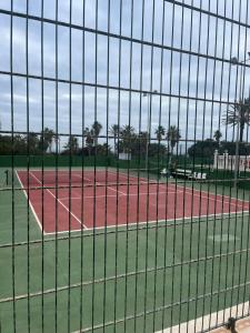 a tennis court seen through a tennis court net at MIRAMAR V in Torrevieja