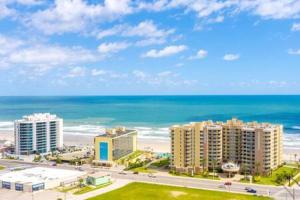 a view of a beach with buildings and the ocean at Newly Remodeled Beachfront Studio with Pool in Daytona Beach
