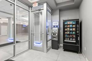 a grocery store with a drink cooler and a soda machine at Newly Remodeled Beachfront Studio with Pool in Daytona Beach