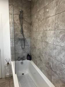 La salle de bains est pourvue d'une douche et d'une baignoire. dans l'établissement Newly refurbished flat - Callander, à Callander