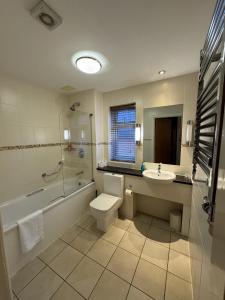 a bathroom with a toilet and a sink and a shower at Blaby Westfield Hotel in Leicester