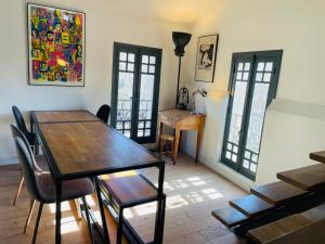 - une salle à manger avec une table et des chaises en bois dans l'établissement Loft 120m2 avec Terrasse Centre Historique, à Montpellier