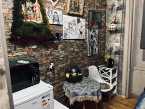 a room with a table and some pictures on the wall at Lets Go - Apartment in Tbilisi City