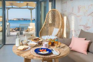 a table with food on it in a living room at Sirma Beach House in Kimolos