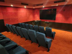 a conference room with chairs and a flat screen tv at Downtown Oasis, Burj Khalifa Views, Luxury Amenities in Dubai