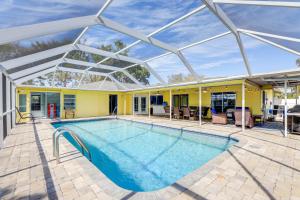 an indoor swimming pool with a glass roof at Sarasota Home with Heated Pool 3 Mi to Airport! in Sarasota