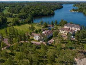 an aerial view of a house next to a lake at Hotell Grelsby Strand in Godby