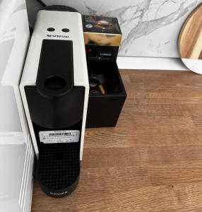 a black and white coffeemaker sitting next to a box at Modern 1 bedroom apartament in Turnu Măgurele