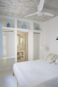 a bedroom with a white bed with blue vases on the ceiling at Luxury Houses La Mar de Bonita in Guardamar del Segura