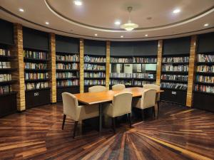 a library with a table and chairs and bookshelves at Downtown Oasis, Burj Khalifa Views, Luxury Amenities in Dubai