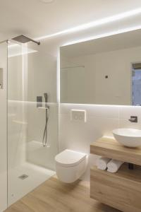 a bathroom with a toilet and a sink and a shower at Luxury Houses La Mar de Bonita in Guardamar del Segura
