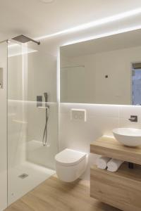 a bathroom with a toilet and a sink and a shower at Luxury Houses La Mar de Bonita in Guardamar del Segura +15 photos