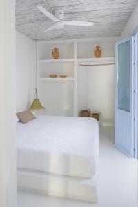 a white bedroom with a white bed and a ceiling at Luxury Houses La Mar de Bonita in Guardamar del Segura