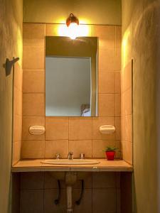 a bathroom with a sink and a mirror at Narciso Home in Cafayate