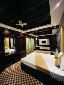 a bedroom with a large bed and a mirror at Hotel Istanbul in Sylhet