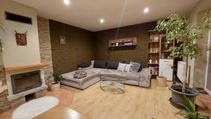 a living room with a couch and a fireplace at Apartmán Gaidi in Zlín