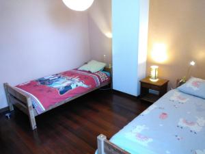 a small bedroom with two beds and a table at Gîte Clé des Champs in Saint-Laurent-en-Royans