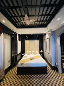 a bedroom with a large bed with a ceiling at Hotel Istanbul in Sylhet