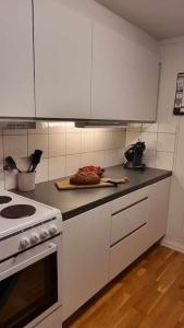 a kitchen with white cabinets and a counter top at Leilighet på Bekkeli, Beito. in Beitostøl