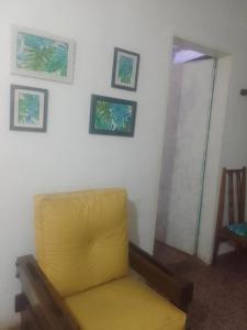 a yellow chair in a room with a mirror at Shark in Paso de los Libres