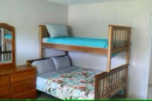 a bedroom with two bunk beds and a dresser at Vistabella Beach House - Pool, Beach - 12ppl in El Porvenir
