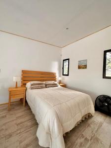 a bedroom with a large bed and a wooden table at PuroBeach in Mar Azul