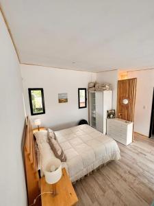 a bedroom with a bed and a table in it at PuroBeach in Mar Azul