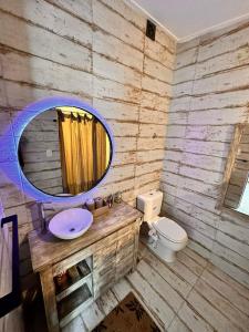 a bathroom with a sink and a mirror and a toilet at PuroBeach in Mar Azul