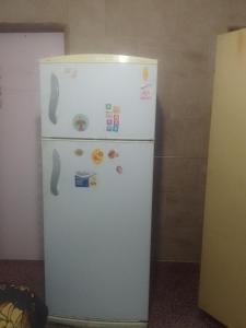 a white refrigerator in a kitchen with magnets on it at Shark in Paso de los Libres