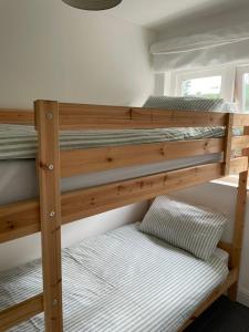 two bunk beds in a room with a pillow at Tewyn Cottage - Charming 2 bed getaway in the SW! in Hayle