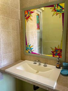 a bathroom sink with a large mirror above it at Narciso Home in Cafayate
