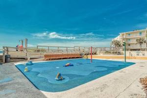a blue area with a playground in front of the beach at The Scallop by Brightwild-Beachfront Condo in Destin