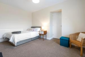 a bedroom with a bed and a chair at Sperrin Mountain Escape in Derry Londonderry
