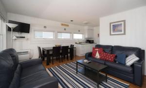 a living room with a couch and a table at The Montauk Soundview in Montauk