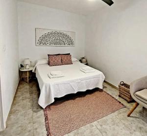 a bedroom with a bed and a chair in it at Villa Del Cabo in Águilas