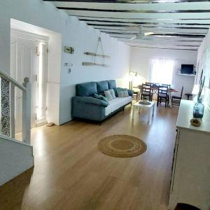 a living room with a blue couch and a table at Villa Del Cabo in Águilas +11 photos