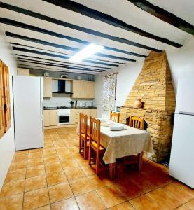 a kitchen with a table and chairs and a refrigerator at Villa Del Cabo in Águilas