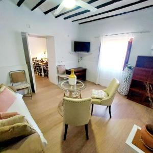 a living room with a couch and a table and chairs at Villa Del Cabo in Águilas