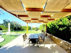 a patio with a table and chairs under a pavilion at Villa Del Cabo in Águilas