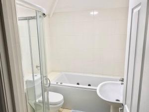 a white bathroom with a toilet and a sink at 4 bed House Royal Leamington Spa with free parking in Leamington Spa