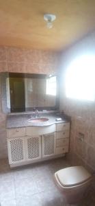 a bathroom with a sink and a toilet at Vilarejo Ecológico terra de canaã in Brasília