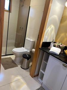 a bathroom with a toilet and a sink at Lofts Urbano in Urubici +57 photos