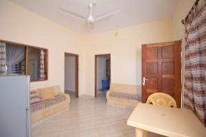 a living room with two beds and a table at Watamu GK Palms in Watamu