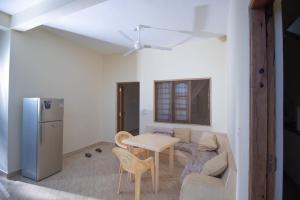 a living room with a table and a couch at Watamu GK Palms in Watamu